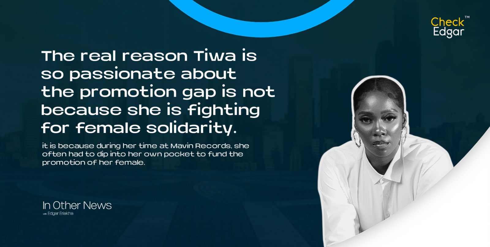 Tiwa Savage sits in a white shirt, looking directly at the viewer with a city backdrop behind her.