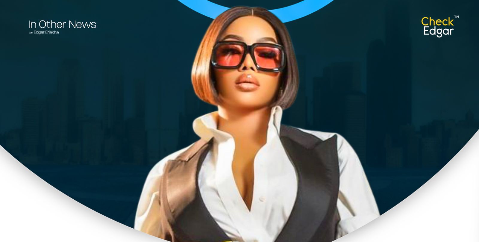 Toke Makinwa wearing oversized sunglasses and a tailored outfit stands with a serious expression.