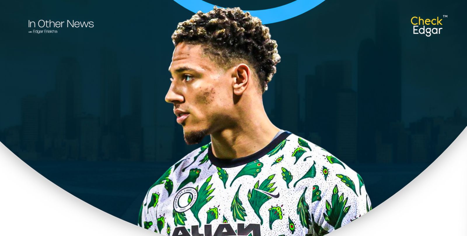 Maduka Okoye with curly hair wearing a patterned jersey looks sideways.