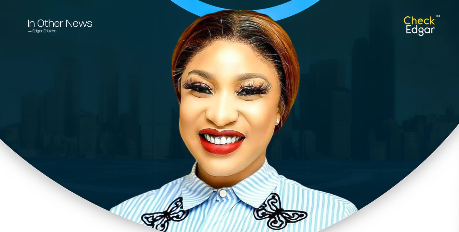 Tonto Dikeh with red lipstick and long eyelashes wearing a striped shirt with butterfly designs.
