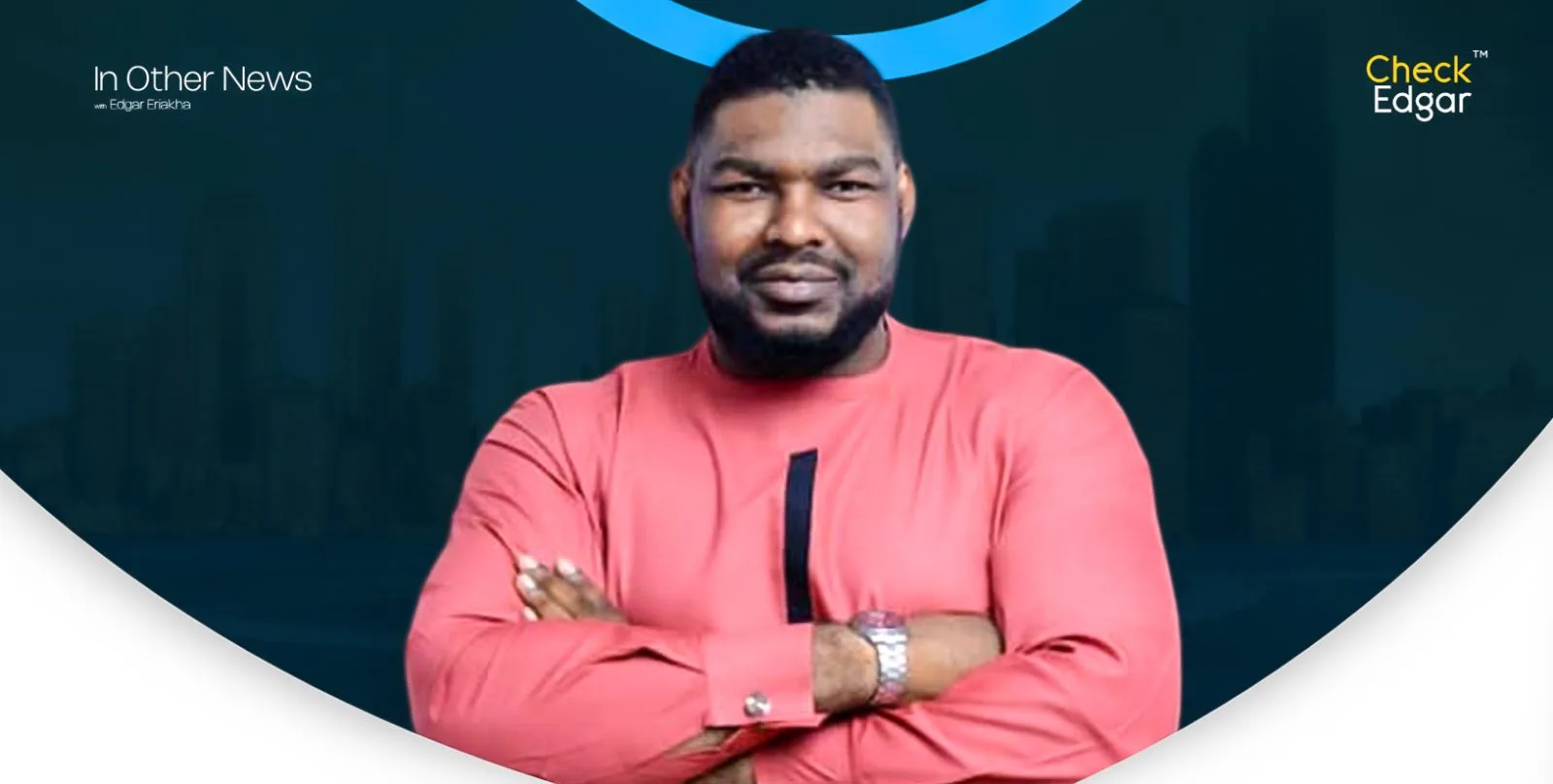 Prophet Okeke in a pink traditional outfit poses confidently with arms crossed.