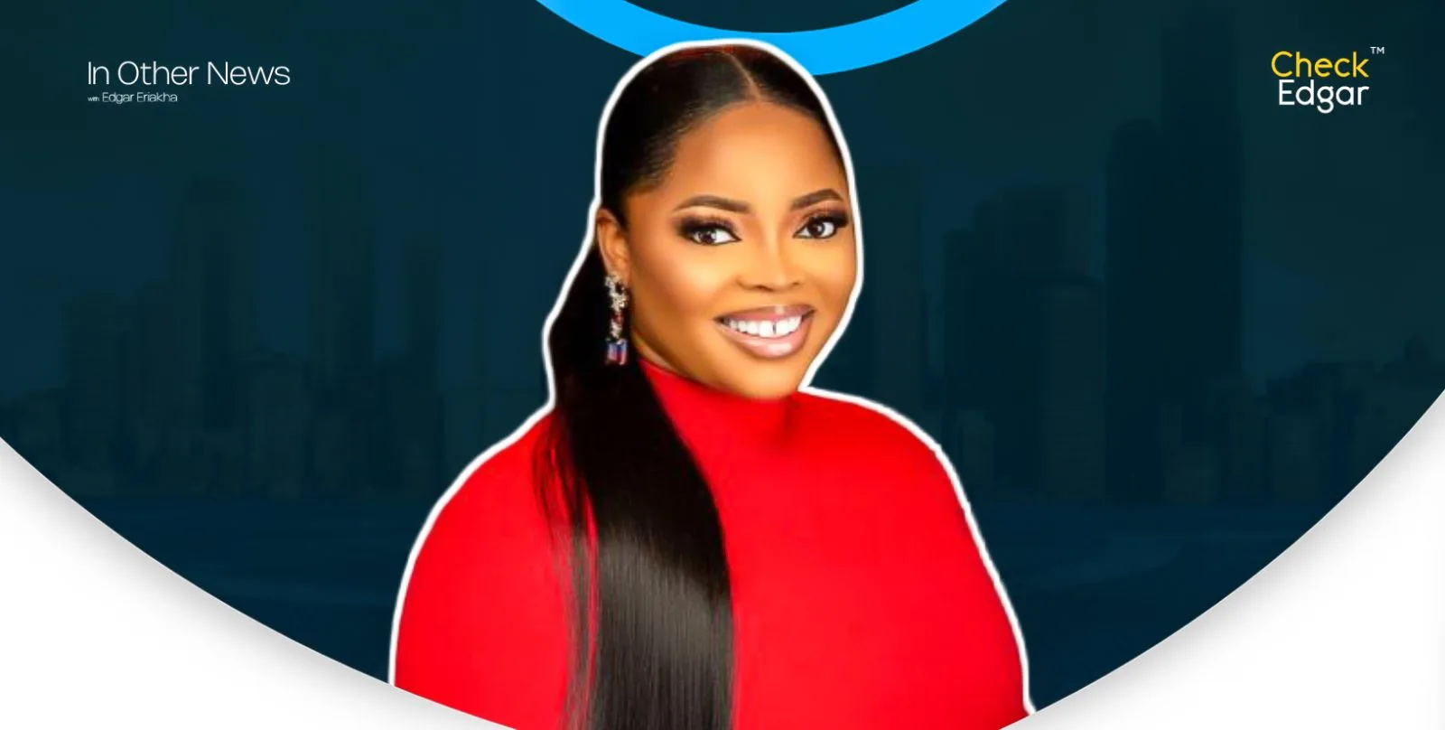 Juliana Olayode with long hair smiles brightly in a red top.