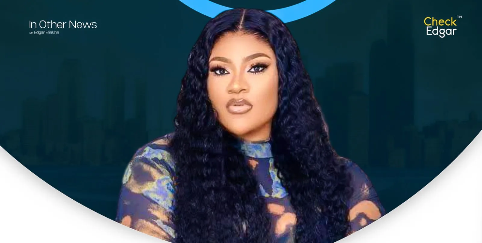 Nkechi Blessing with long, wavy hair poses confidently in a colourful outfit.