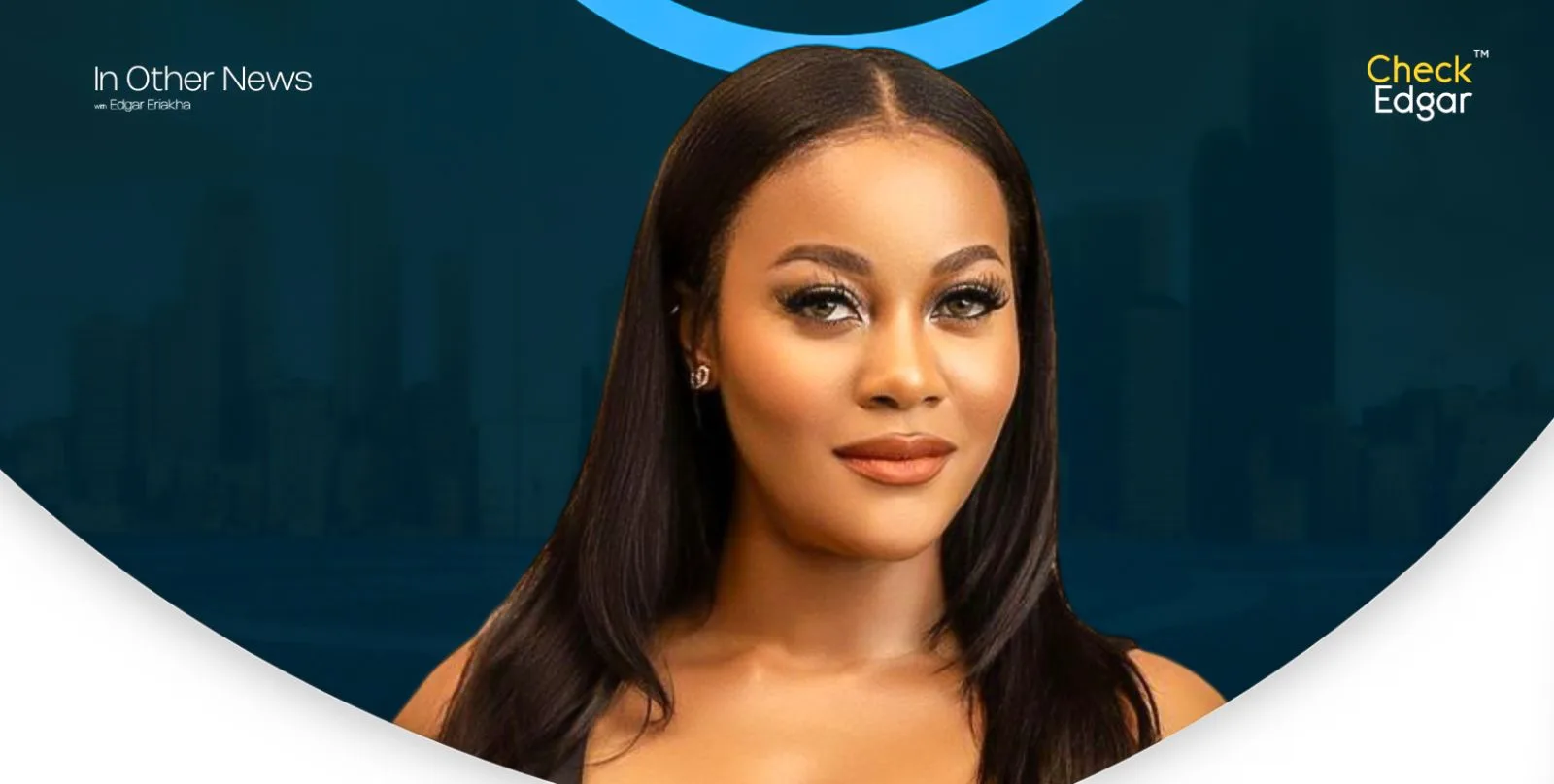 Damilola Adegbite with long dark hair and makeup smiles at the camera.