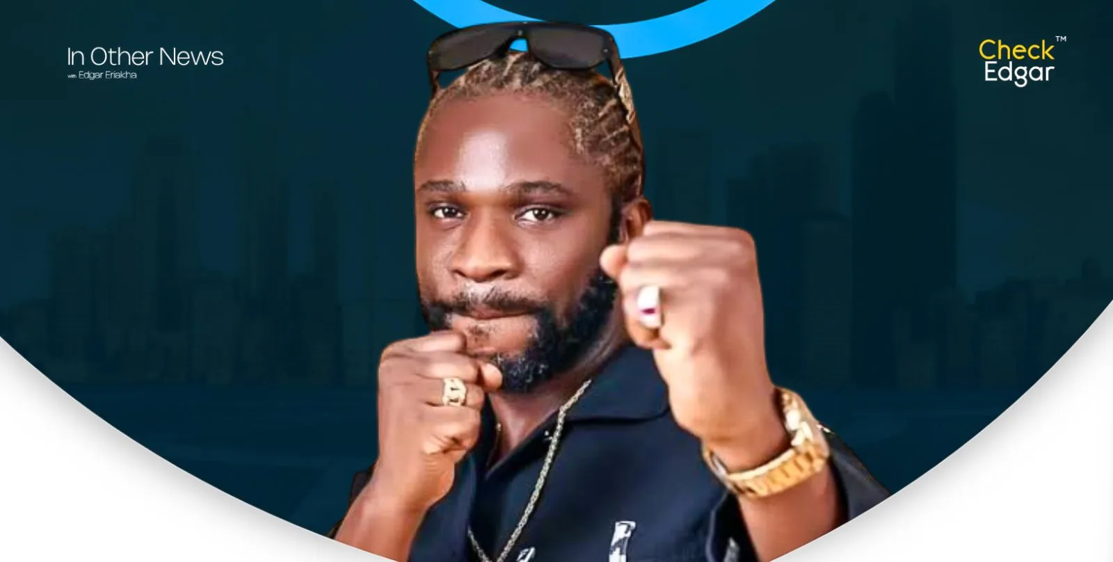 Speed Darlington with braided hair and sunglasses poses with clenched fists.