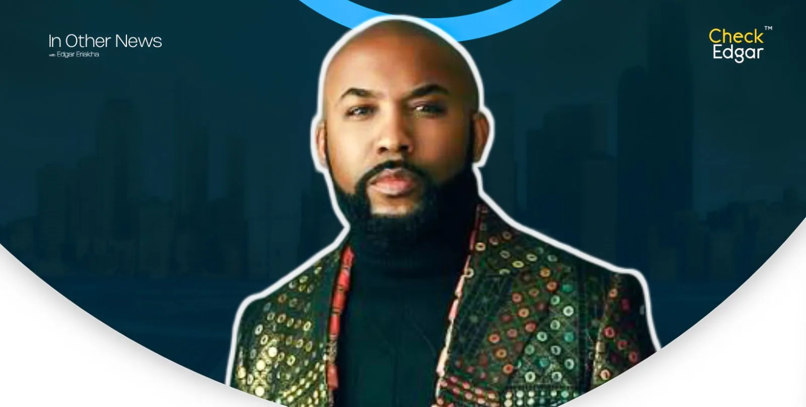 Banky W with a beard wearing a patterned jacket.