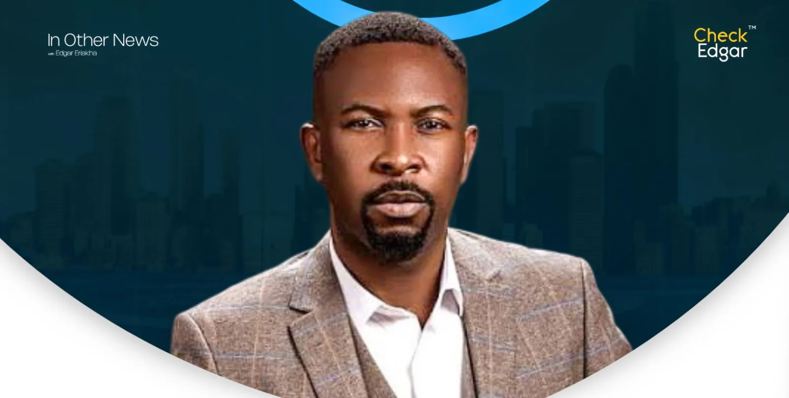 Close-up of Ruggedman  with a short beard, wearing a suit.