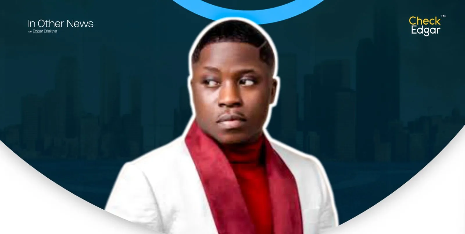 Fekomi with a stylish haircut wearing a white suit and red scarf, looking to the side.