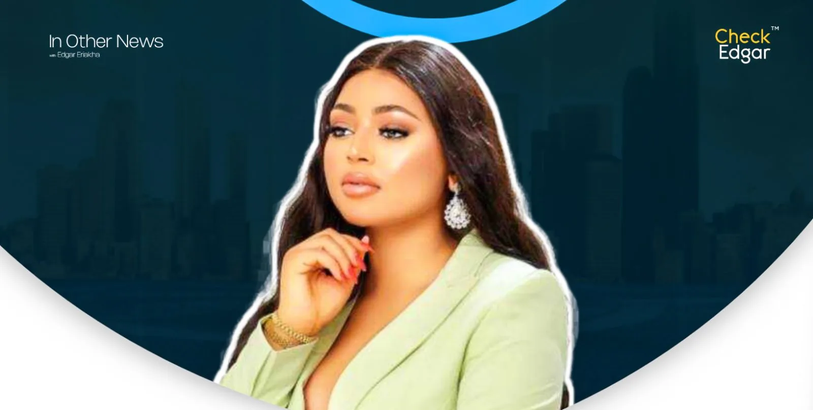 A close-up of Regina Daniels with long hair and earrings, dressed in a green suit.