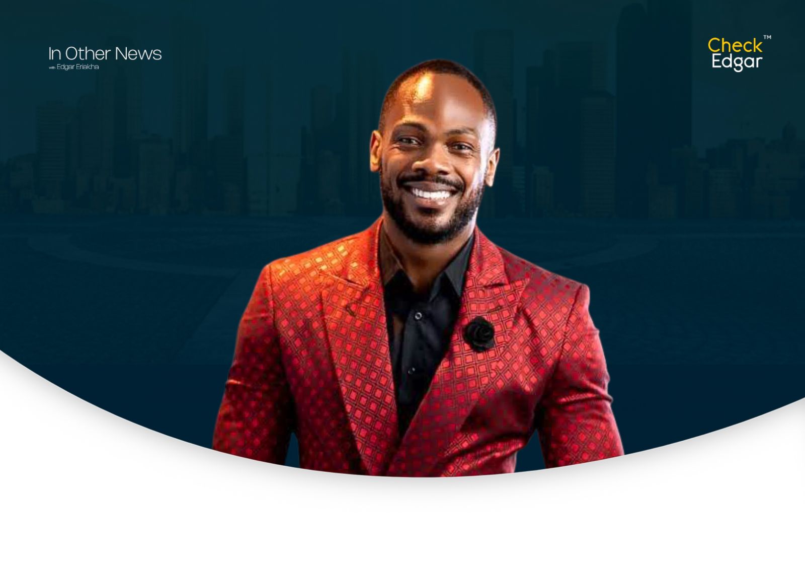 Daniel Etim wearing a red suit with geometric patterns.