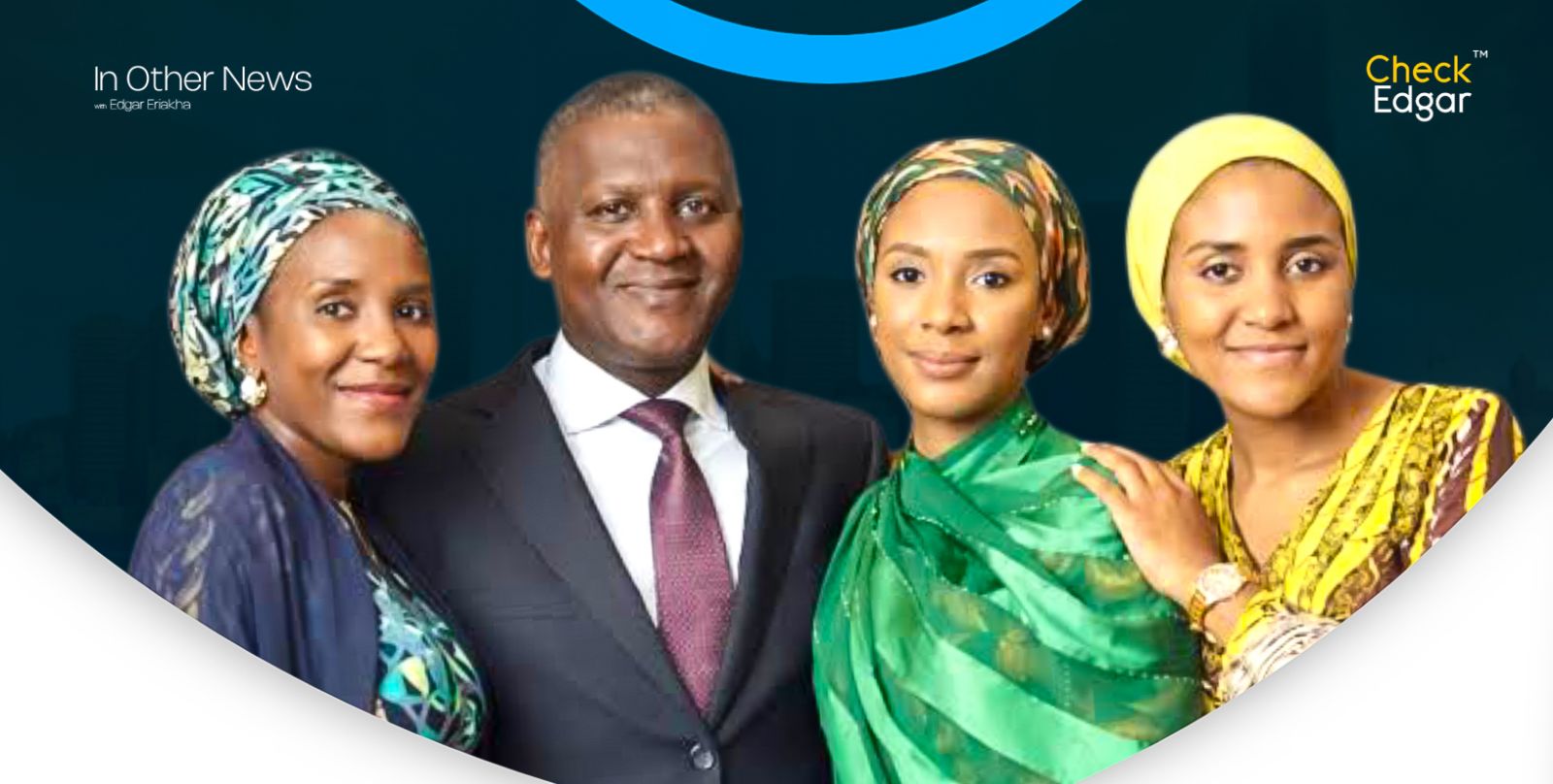 Dangote in a suit stands with his three daughters.