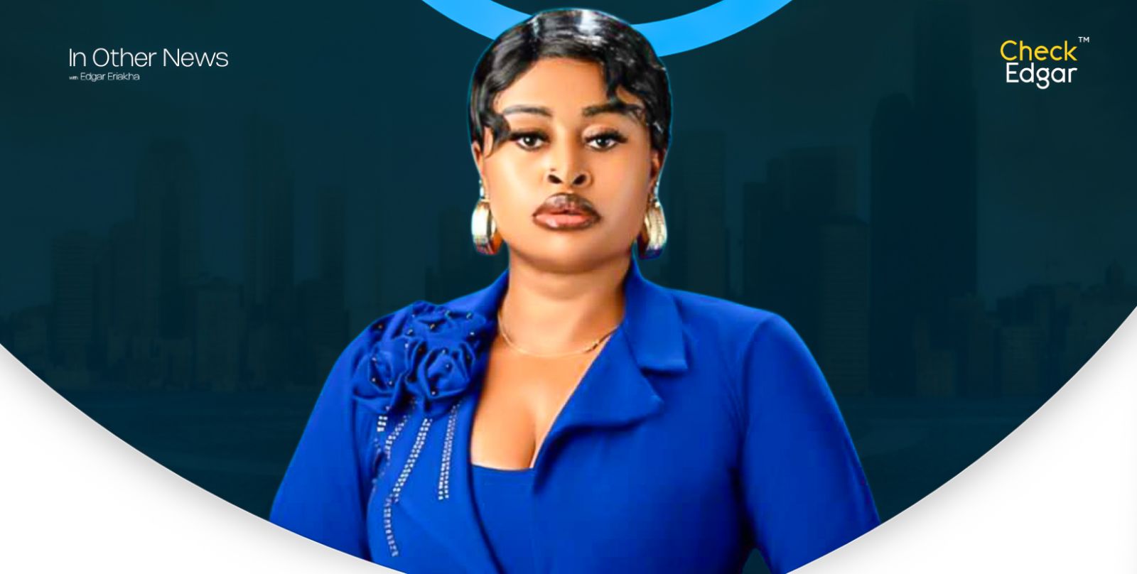 A close-up of Sarah Martins wearing a blue blazer, featuring a decorative flower.