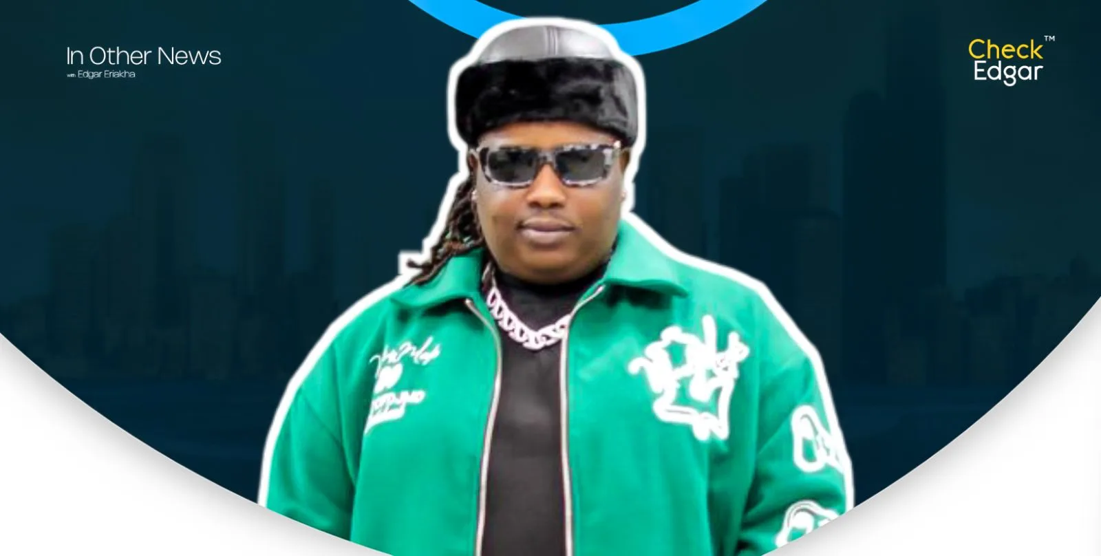 Barry Jhay wearing sunglasses and a green jacket with a black fur hat.