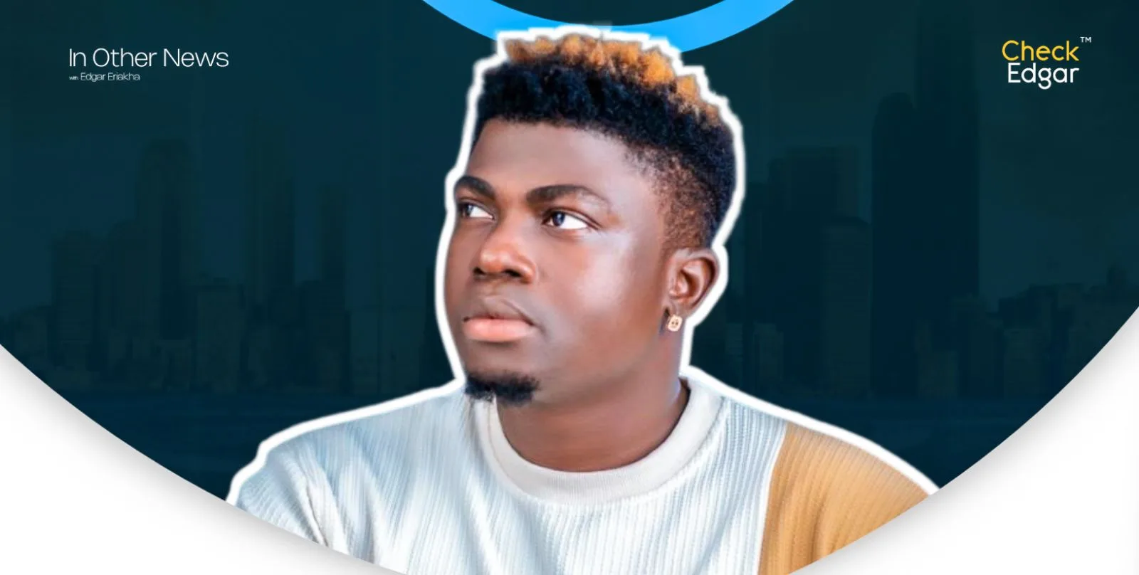 Hakeem Effect with short, styled hair looking upwards, wearing a light sweater.