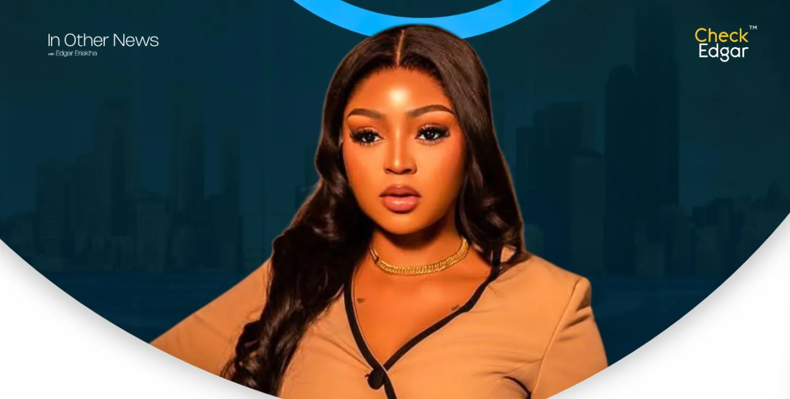 Close-up of Regina Daniels in a stylish outfit, with a neutral expression and long hair.